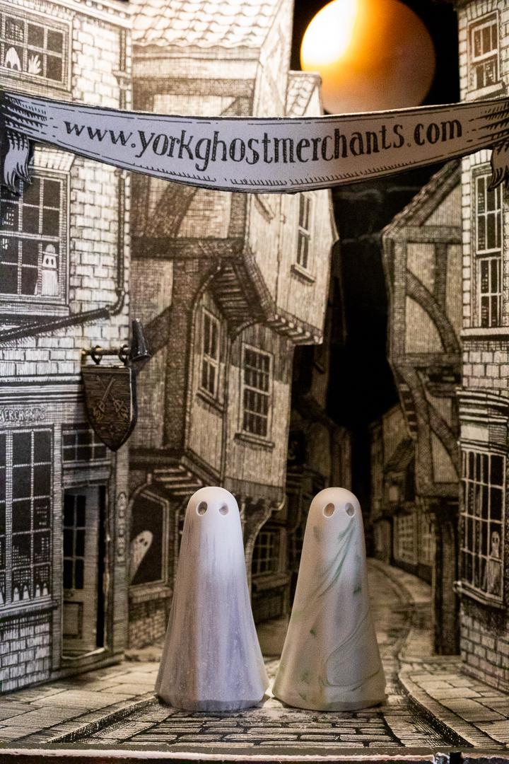 A pair of Ghosts in a street beneath a banner from York Ghost Merchants